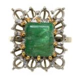 AN EMERALD COCKTAIL RING, IN WHITE GOLD MARKED 18CT WITH OPENWORK SURROUND, THE EMERALD APPROX 3.