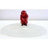 A FLAMBE GLAZED MODEL OF A SEATED MONKEY ATTRIBUTED TO BERNARD MOORE, AFFIXED TO CONTEMPORARY 1920'S