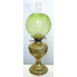 A VICTORIAN EMBOSSED BRASS OIL LAMP WITH CONTEMPORARY GLOBULAR GREEN SHADED AND ETCHED GLASS
