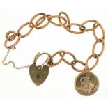 A 9CT GOLD CURB LINK BRACELET WITH 9CT PADLOCK CLASP AND 9CT MEDALLION, 18.5G++LIGHT WEAR CONSISTENT