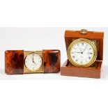 AN ASPREY BRASS MOUNTED AND VARNISHED WOOD CASED TRAVELLING LACQUERED BRASS ALARM TIMEPIECE WITH