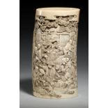 A JAPANESE IVORY VASE, MEIJI PERIOD carved from a section of tusk with continuous scenes including