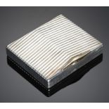 CARTIER. A STYLISH SILVER CIGARETTE CASE, C1930 of heavy gauge with chevron-reeded lid and