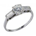 A DIAMOND RING with round brilliant and baguette cut diamonds to the shoulders, in platinum, maker