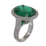 AN EMERALD AND DIAMOND RING with pave set diamond surround and shoulders, in platinum marked