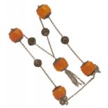 A NECKLACE OF FIVE AMBER BEADS AND FILIGREE SILVER COLOURED METAL, C1920 133.6g++Good condition