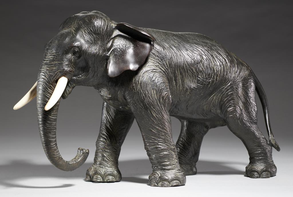 A JAPANESE BRONZE SCULPTURE OF AN ELEPHANT, MEIJI PERIOD ivory tusks, rich even dark patina, 24.