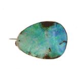 AN ASYMMETRICAL 'ROUGH' OPAL BROOCH plain gold mount, 2.9cm l, unmarked, 8g++Good condition, the