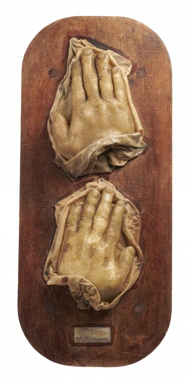 TWO WAX SCULPTURES OF HUMAN HANDS, 19TH C 20 and 22cm l, mounted on varnished softwood board++Dirt/