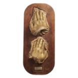 TWO WAX SCULPTURES OF HUMAN HANDS, 19TH C 20 and 22cm l, mounted on varnished softwood board++Dirt/