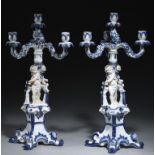 A PAIR OF GERMAN FLORAL ENCRUSTED BLUE AND WHITE CANDELABRA, EARLY 20TH C of four lights supported