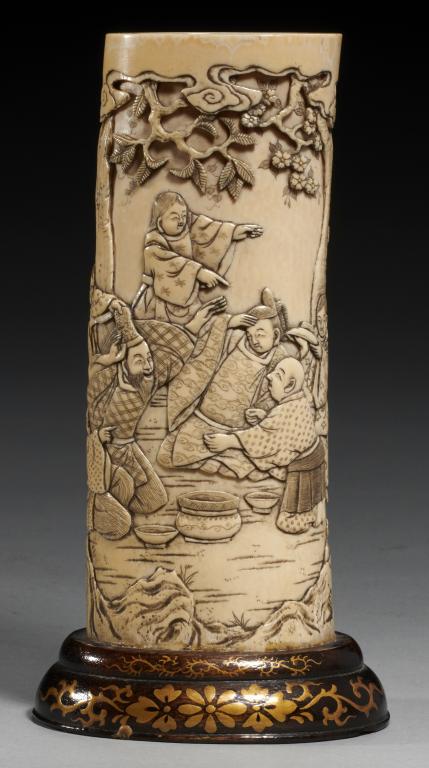 A JAPANESE IVORY VASE, MEIJI PERIOD carved from a section of tusk with a continuous scene with
