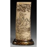 A JAPANESE IVORY VASE, MEIJI PERIOD carved from a section of tusk with a continuous scene with