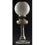 A VICTORIAN BRASS MOUNTED CUT GLASS OIL LAMP, C1870 with brass burner and an etched shade, 54cm h++