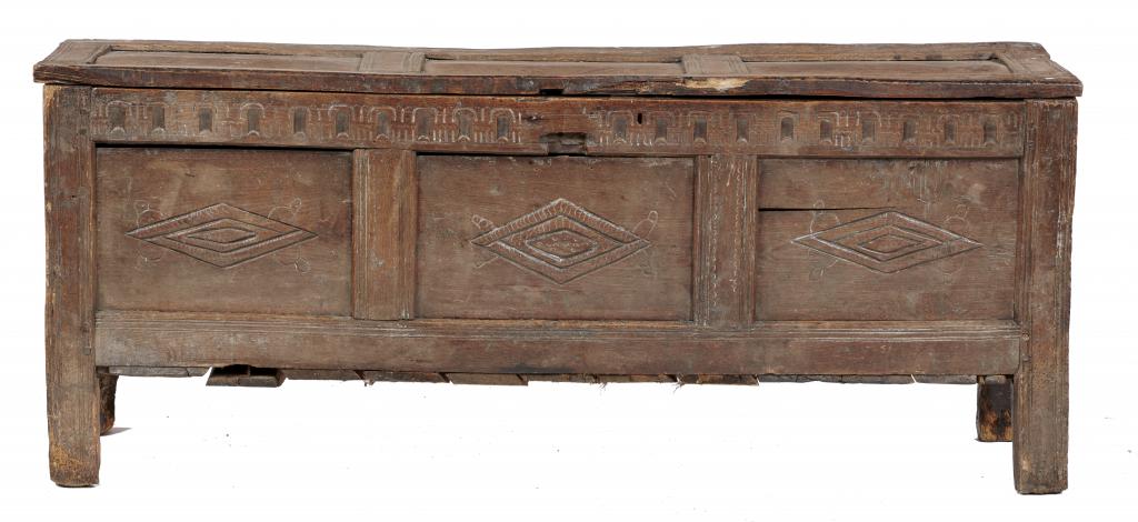 A CHARLES II OAK CHEST, C1660-80 with nulled frieze above three lozenge carved panels, on channelled