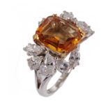 A TOPAZ AND DIAMOND RING the step cut topaz approximately 0.8 x 0.9cm between an asymmetrical