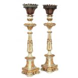 A PAIR OF CONTINENTAL CARVED, GILT AND PAINTED WOOD CANDLESTICKS WITH BLUE AND RED PAINTED SHEET