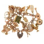 A 9CT GOLD CHARM BRACELET THE CHARMS INCLUDING A MASONIC BALL FOB AND A TWO COLOUR 22CT GOLD WEDDING