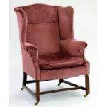 A GEORGE III STYLE MAHOGANY WING BACK ARMCHAIR ON BRASS CASTORS, EARLY 20TH C