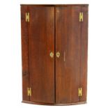 AN EARLY 19TH C OAK BOW FRONTED CORNER CUPBOARD, 97CM H X 64CM W