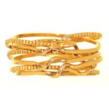A MULTIPLE BAND RING IN GOLD, COMPRISING SEVEN INTERLINKED BANDS, 2.5G, SIZE N++IN GOOD CONDITION,