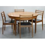 A 1970'S TEAK EXTENDING DINING TABLE AND A SET OF FOUR TEAK DINING CHAIRS