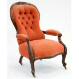 A VICTORIAN CARVED WALNUT ARMCHAIR, UPHOLSTERED IN RED BUTTONED FABRIC