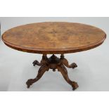 A VICTORIAN WALNUT LOO TABLE WITH QUARTER VENEERED TOP, ON CARVED BASE, 70CM H; 137 X 99CM