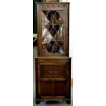 A GLAZED AND CARVED OAK CORNER CABINET, 183CM H