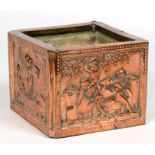 AN EMBOSSED COPPER CACHE POT, EACH SIDE WITH A PANEL OF PUTTI GRAPE HARVESTERS, 12CM H, EARLY 20TH