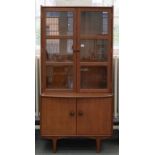 A 1970'S STAINED TEAK BOW FRONTED CABINET, THE UPPER PART WITH GLAZED DOORS, 187CM H X 92CM W