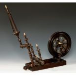 A GEORGE III MAHOGANY AND FRUITWOOD TABLE TOP SPINNING WHEEL, C1800, on moulded rectangular base the