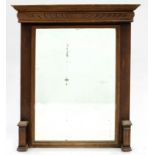 A CARVED OAK MIRROR WITH BEVELLED PLATE, 116 X 91CM