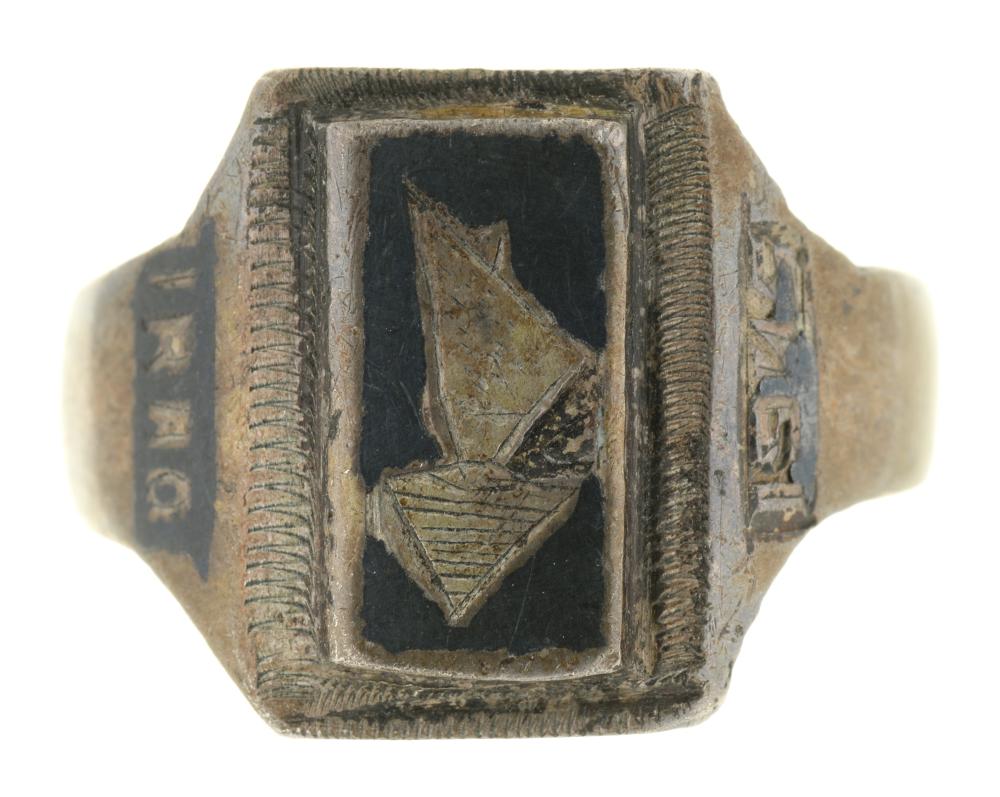 A SILVER RING, WITH LABEL STATING "MADE FROM A HALF CROWN IN 1945 IN BASRA IRAQ WHILST STATIONED