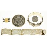 A MIDDLE EASTERN SILVER COIN BROOCH, A MEXICAN SILVER BROOCH, AN ENGRAVED SILVER BRACELET AND