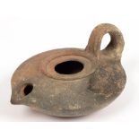 A ROMAN POTTERY OIL LAMP, 7CM D, SECOND CENTURY AD