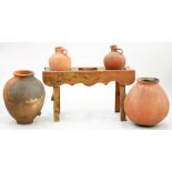 FOUR CONTINENTAL TERRACOTTA POTS AND A STAINED WOOD STAND, 60CM H; 109 X 36CM, EARLY 20TH C