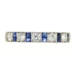 AN ART DECO MILLEGRAIN SET CALIBRE SAPPHIRE AND BRILLIANT CUT DIAMOND ETERNITY RING, ENGRAVED