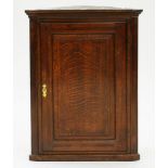 A VICTORIAN OAK CORNER CUPBOARD WITH PANELLED DOOR, 96CM H X 72CM W