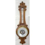 AN OAK ANEROID BAROMETER, INCORPORATING A THERMOMETER