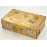 A VELLUM COVERED SUITCASE, LABELLED W. E. JACKSON AND SON NOTTINGHAM WITH NUMROUS TRAVEL LABELS,