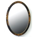 AN OVAL BLACK JAPANNED WALL MIRROR, C1930