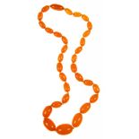 A BUTTERSCOTCH AMBER BEAD NECKLACE, OF THIRTY ONE OLIVE SHAPED BEADS GRADUATING FROM APPROXIMATELY