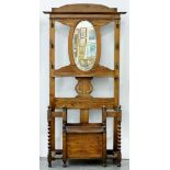 AN OAK HALL STAND , THE BACK WITH OVAL MIRROR, 95CM L, EARLY 20TH C