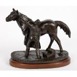 A BRONZED RESIN SCULPTURE OF A FARRIER AND HORSE, 13CM H