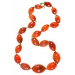 A CARNELIAN BEAD NECKLACE, THE OLIVE SHAPED BEADS GRADUATING FROM 1.2CM TO 2CM, APPROX. 45 CM