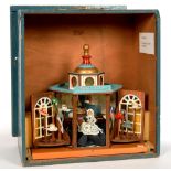 A PAINTED WOOD MODEL OF A VICTORIAN HAT SHOP, WITH SHOPKEEPER DOLL IN VICTORIAN STYLE BLUE SILK