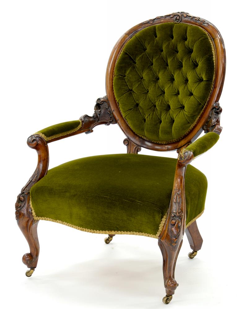 A VICTORIAN CARVED WALNUT ARMCHAIR, UPHOLSTERED IN GREEN FABRIC