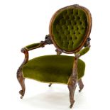 A VICTORIAN CARVED WALNUT ARMCHAIR, UPHOLSTERED IN GREEN FABRIC