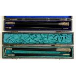 TWO ENGLISH SILVER MOUNTED EBONY CONDUCTOR'S BATONS, 46.5CM L AND CIRCA, LONDON 1920 AND 1922,